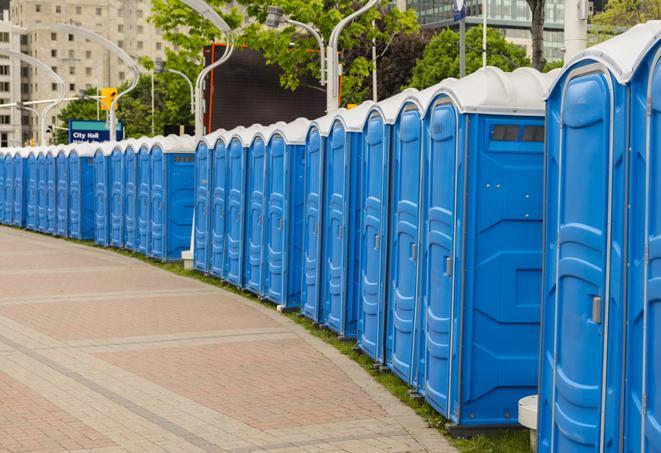 a row of portable restrooms at an outdoor special event, ready for use in Crawfordsville